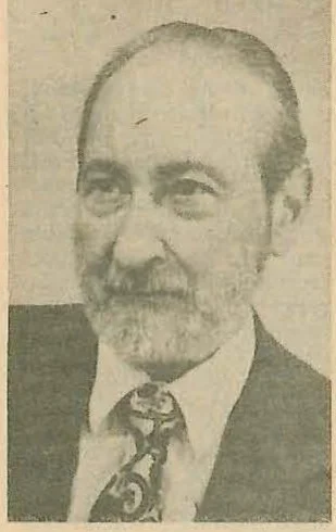 Portrait photograph of Adrian Rogoz, a man with a beard and receding hairline, wearing a suit and tie.